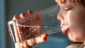 Little girl drinking a fresh glass of water.