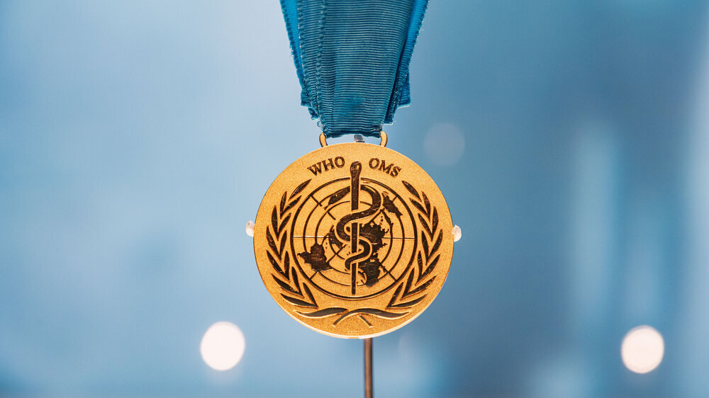 6 December 2025, Abu Dhabi, UAE: World Health Organization - WHO - medal, featuring the symbol of Asclepius and a map of the world