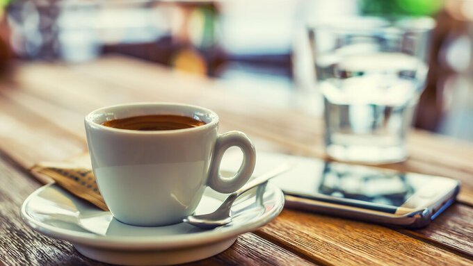 Coffee. Coffee break business. Cup of coffee mobile phone on table on restaurant coffee house terrace. Kaffeepause