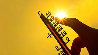 Hot weather - Heat wave / Summer heat background - Thermometer yellow orange sky and sun rays