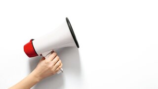 Female hand with megaphone on white background