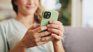 Home, sofa and woman with smartphone for scroll, chat and text message for plans with online contact. Smile, female person and cellphone with dating website for flirting, match partner or mobile app.